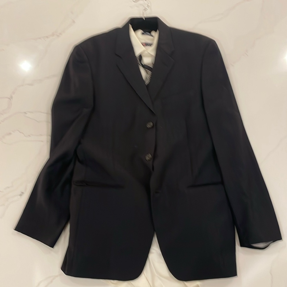 Black suit, white shirt dark multi colored tie